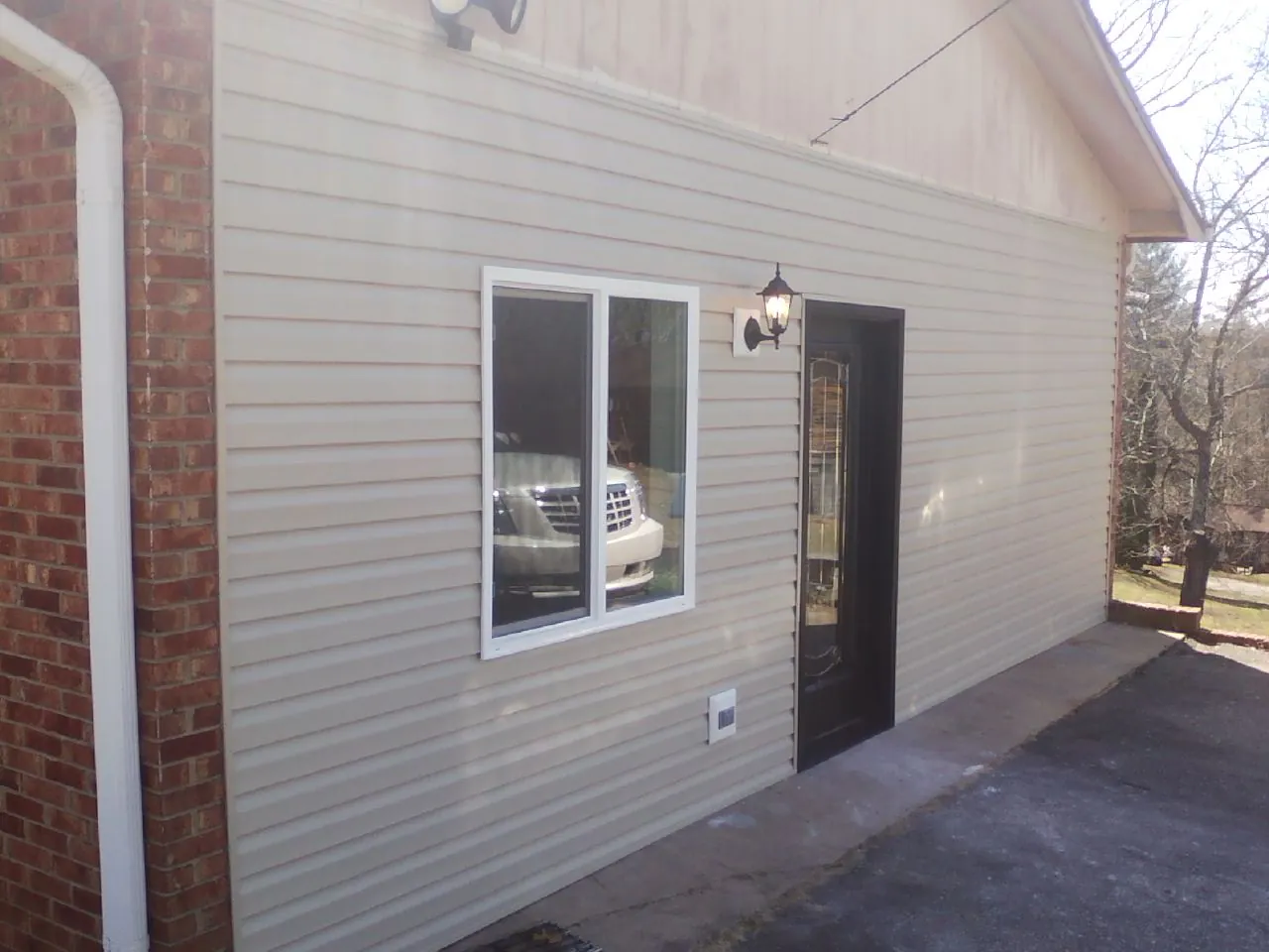 New vinyl siding and entry door on a room addition in Hudgins