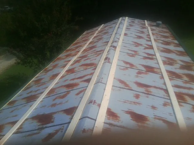 Rusted metal roof panels with new wood purlins before replacement — Storm Damage Roof Repair in Hudgins by Roofing Brothers